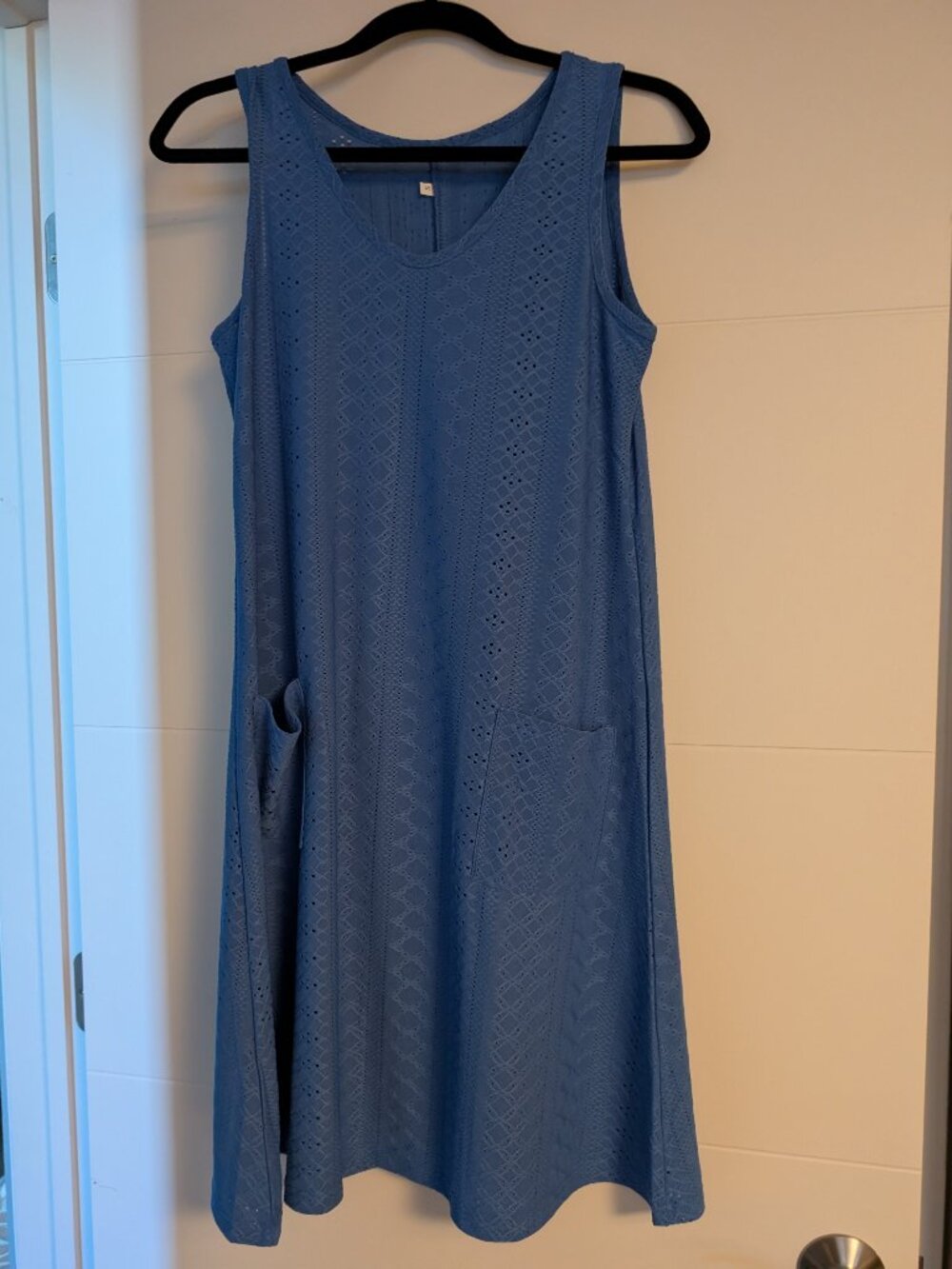 Blue sleeveless summer dress with pockets.
